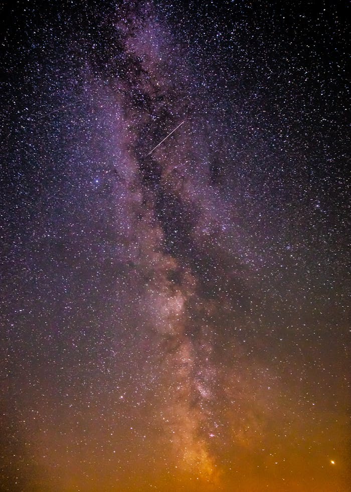 Beautiful shot of the Milky Way galaxy filled with stars and a shooting star.